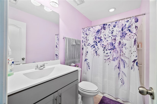 bathroom featuring vanity, a shower with curtain, and toilet