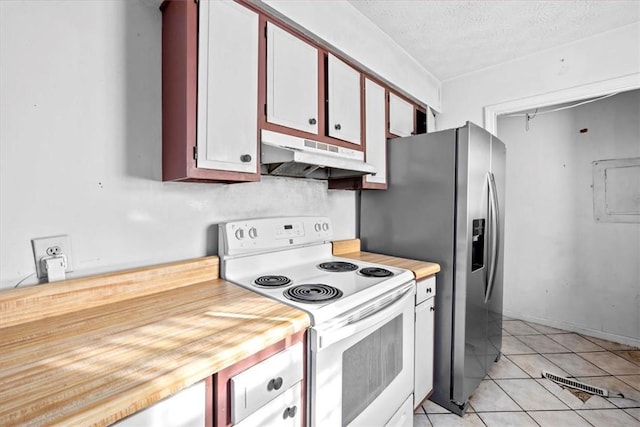 kitchen featuring white electric range, white cabinets, a textured ceiling, and light tile patterned floors