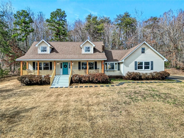 view of front of property with covered porch, a front lawn, crawl space, and a shingled roof