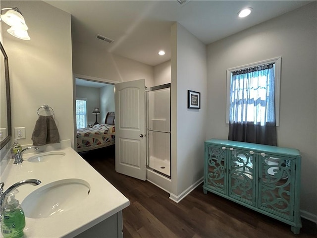 bathroom featuring vanity, an enclosed shower, and hardwood / wood-style floors