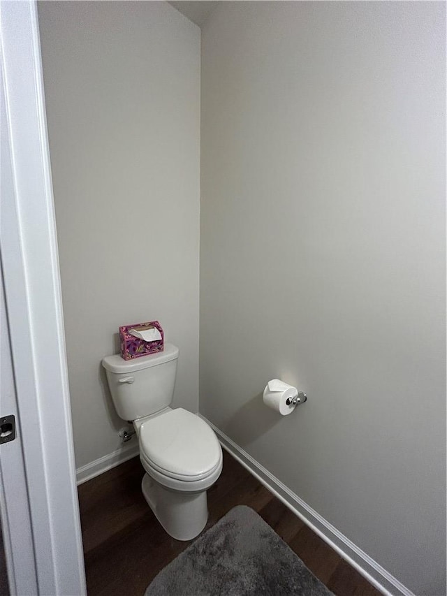 bathroom featuring hardwood / wood-style floors and toilet