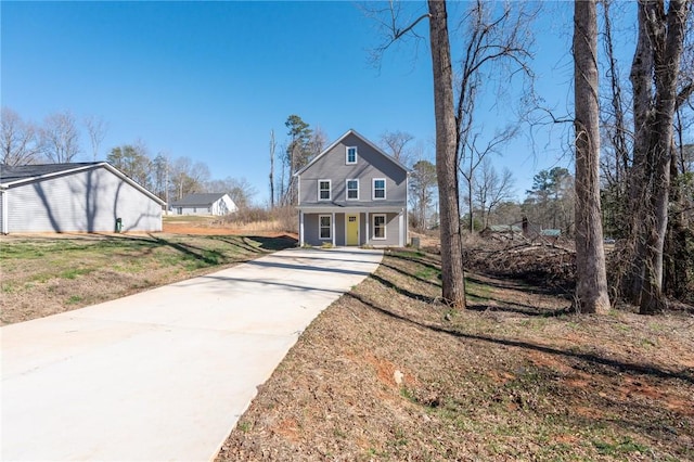 view of front of home with covered porch and a front yard