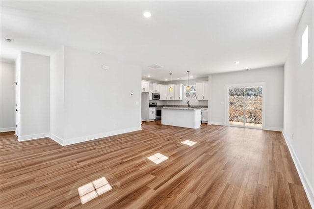 unfurnished living room with light hardwood / wood-style floors