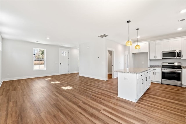 104 Norbert Ln, Anderson, SC 29624 - kitchen with white cabinetry, pendant lighting, a kitchen island, light hardwood / wood-style floors, and stainless steel appliances