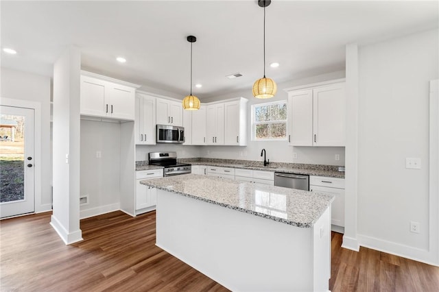 104 Norbert Ln, Anderson, SC 29624 - kitchen with appliances with stainless steel finishes, hanging light fixtures, white cabinets, a kitchen island, and sink