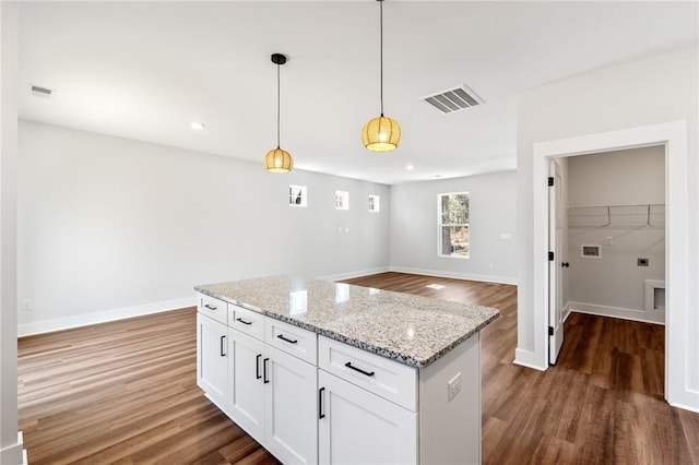 104 Norbert Ln, Anderson, SC 29624 - kitchen featuring hanging light fixtures, white cabinetry, dark wood-type flooring, and light stone countertops
