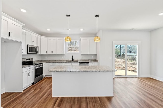 104 Norbert Ln, Anderson, SC 29624 - kitchen with a center island, white cabinets, stainless steel appliances, and decorative light fixtures