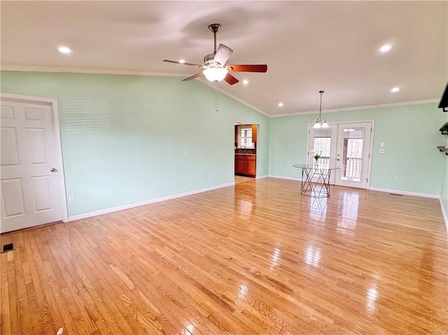 unfurnished living room featuring ceiling fan, light hardwood / wood-style floors, crown molding, and lofted ceiling