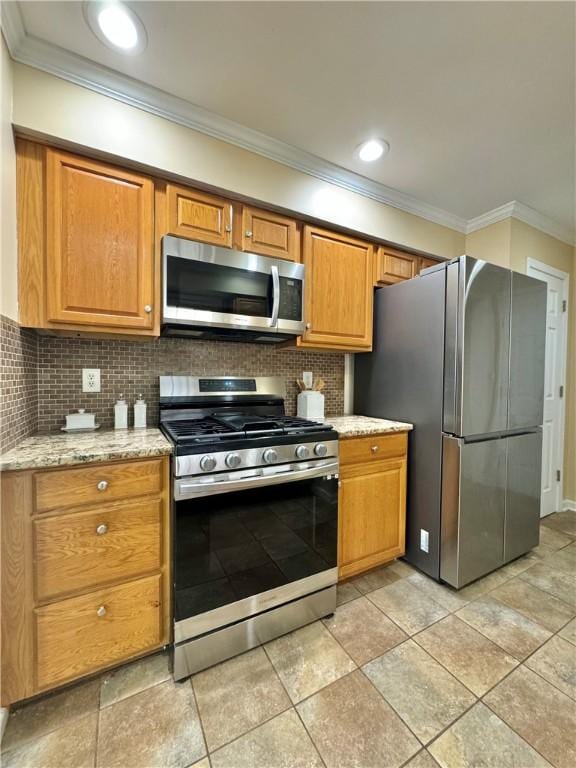 kitchen with stainless steel appliances, backsplash, light stone countertops, and ornamental molding