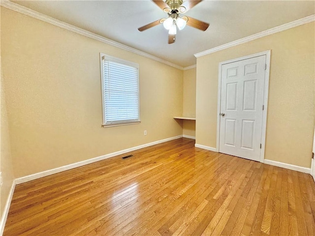 unfurnished room with light wood-type flooring, ornamental molding, and ceiling fan