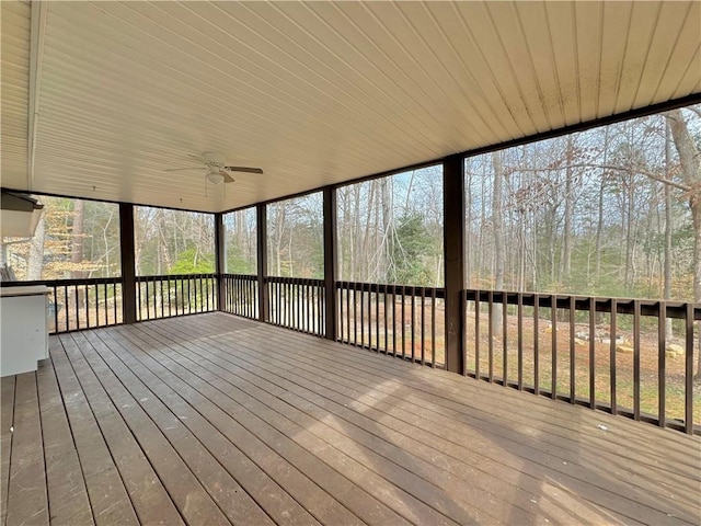 unfurnished sunroom with ceiling fan