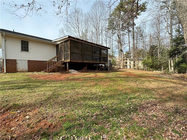 back of property with a yard and a sunroom