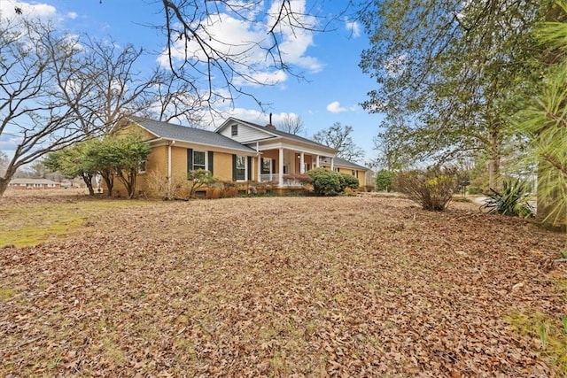 view of front of property featuring a porch and brick siding