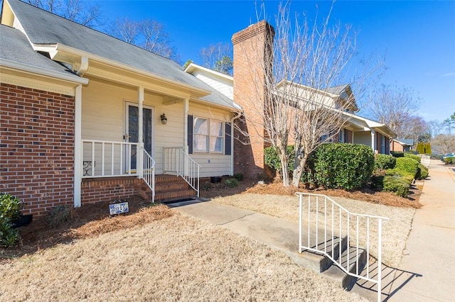 view of exterior entry featuring covered porch