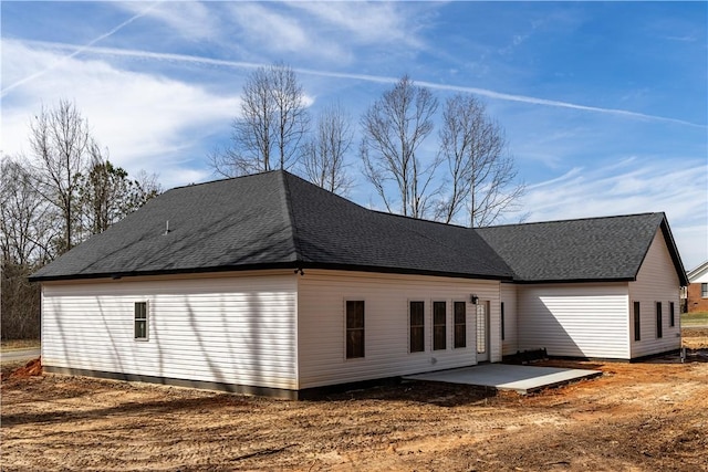 back of property with a patio