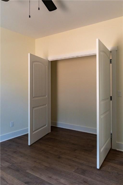 unfurnished bedroom with ceiling fan and dark hardwood / wood-style flooring