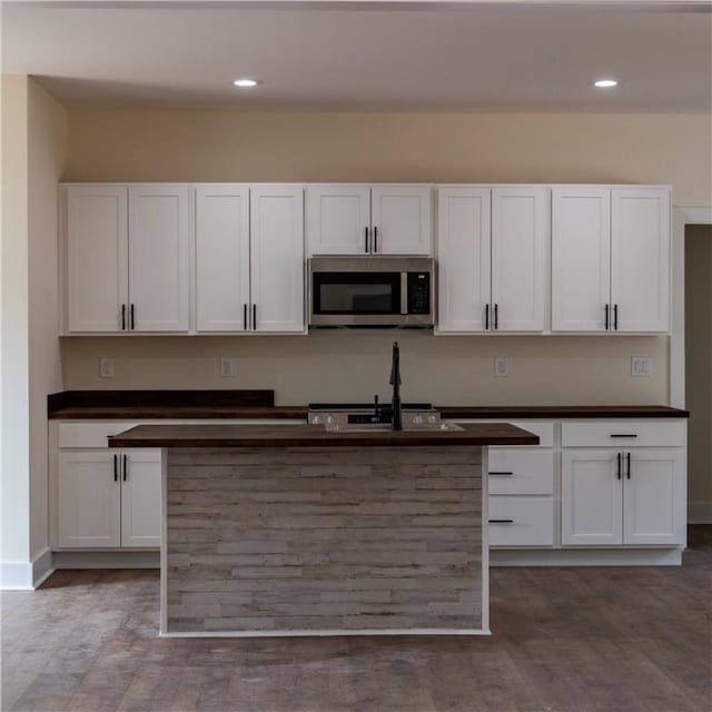 kitchen with white cabinetry and sink