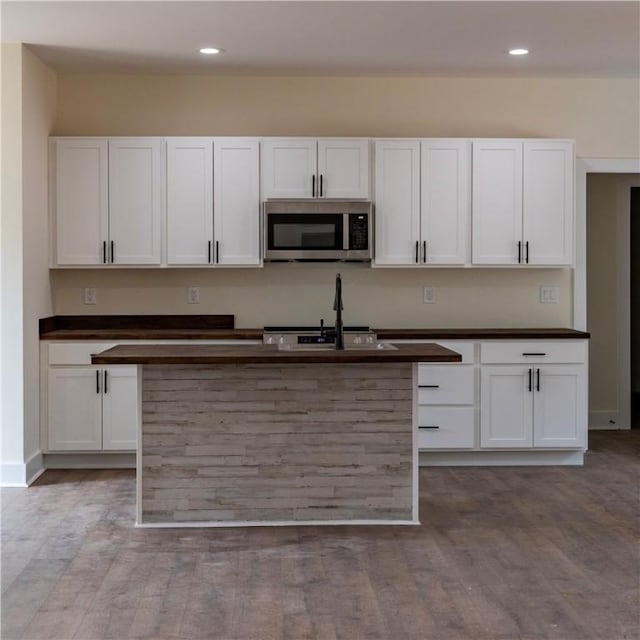 kitchen featuring sink, white cabinetry, and light hardwood / wood-style floors