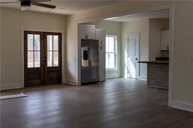 entrance foyer featuring dark hardwood / wood-style flooring, ceiling fan, french doors, and a wealth of natural light