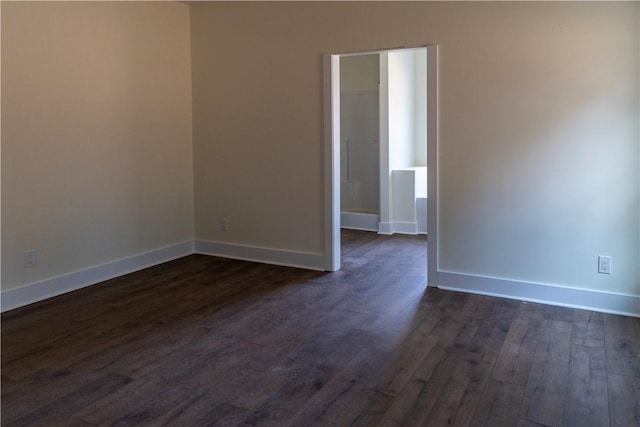 unfurnished room with dark hardwood / wood-style flooring