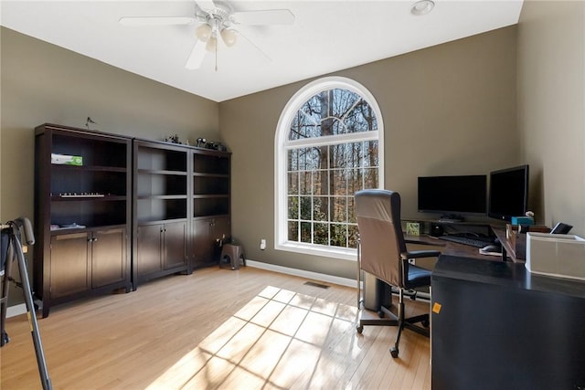 office space with light hardwood / wood-style floors and ceiling fan