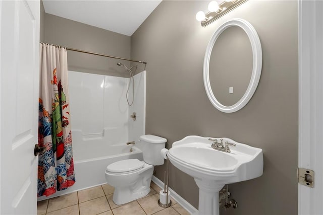 bathroom featuring toilet, shower / bath combo with shower curtain, and tile patterned flooring