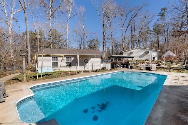 view of pool with an outdoor structure and a patio area