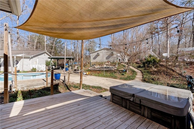 wooden deck featuring a patio area and a swimming pool with hot tub