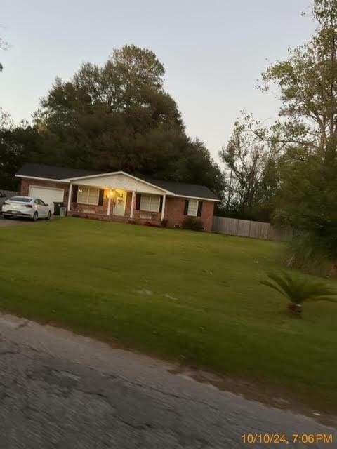 view of front facade featuring a front yard and a garage