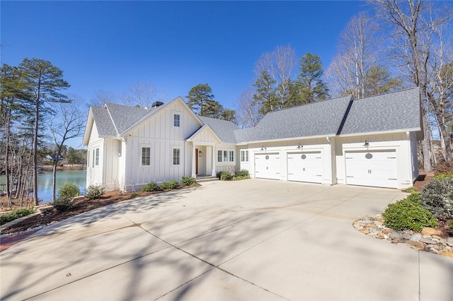 view of front of house with a garage and a water view