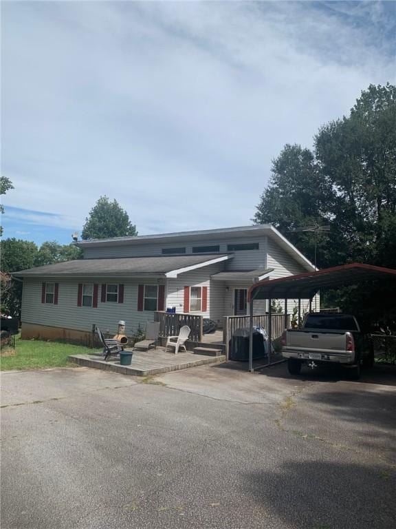 view of front of house featuring a deck and a carport