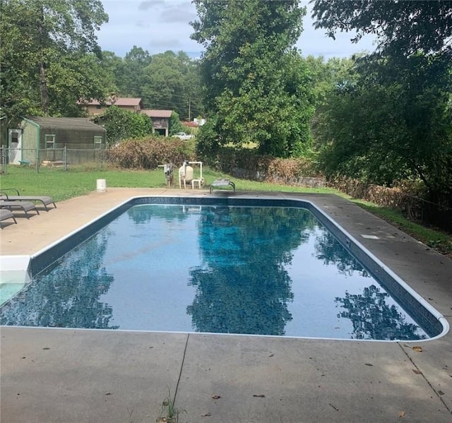 view of pool with a fenced in pool, fence, and a patio