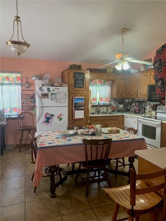 dining space featuring a ceiling fan and light tile patterned floors