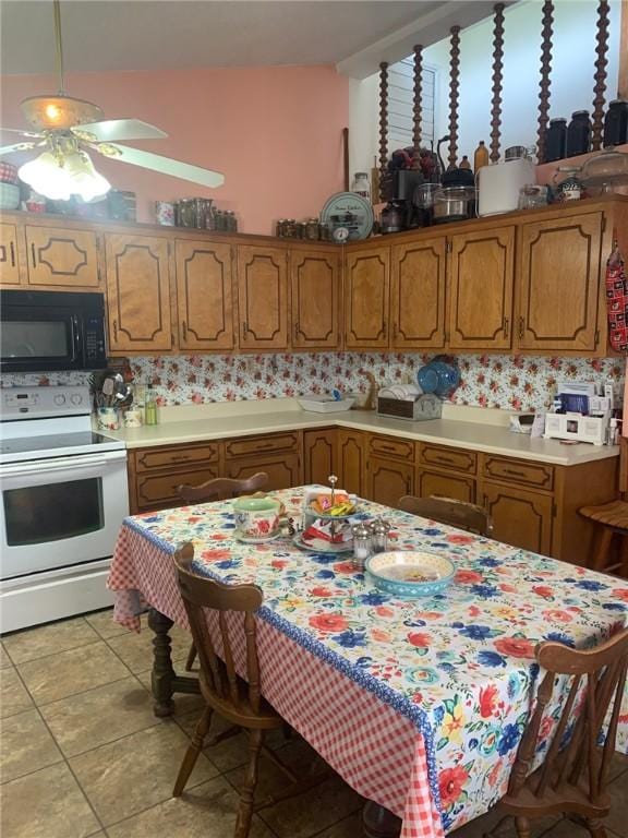 kitchen featuring brown cabinets, white electric range oven, black microwave, ceiling fan, and light countertops