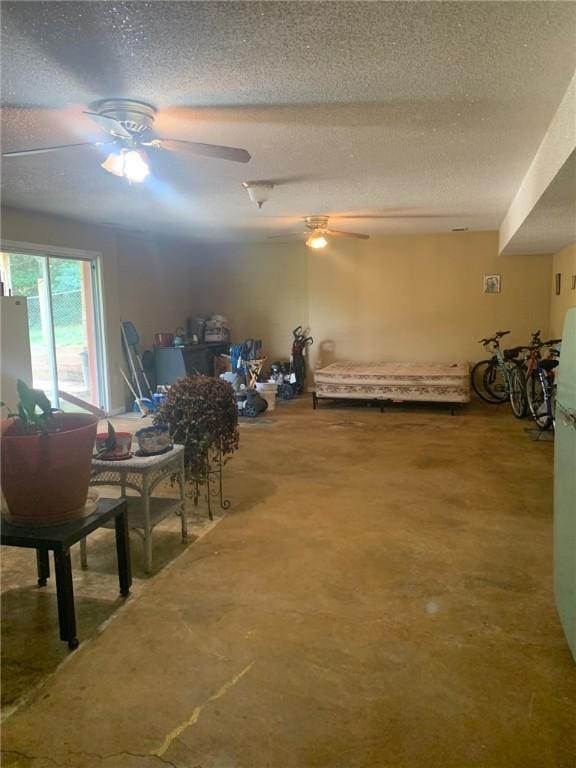 interior space featuring ceiling fan and a textured ceiling