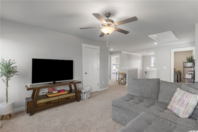 living room featuring light carpet, separate washer and dryer, and ceiling fan