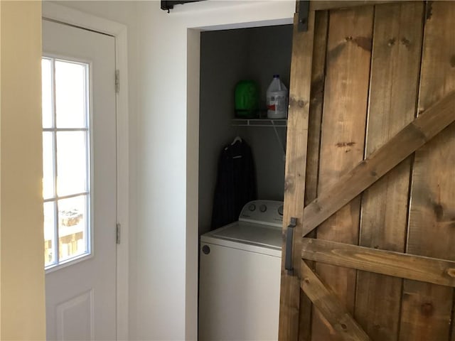 washroom with washer / clothes dryer and a barn door