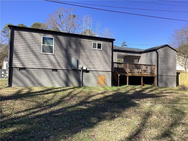 rear view of property featuring a yard and a deck