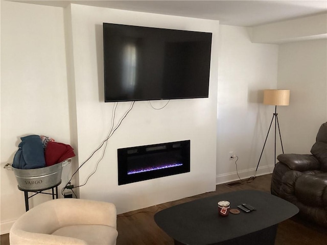 living room with dark hardwood / wood-style flooring