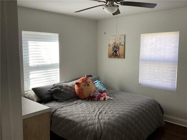 bedroom featuring ceiling fan and multiple windows