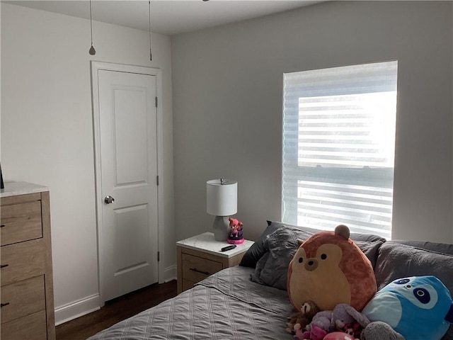 bedroom with dark wood-type flooring