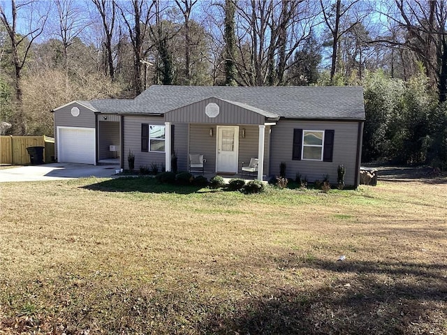 ranch-style home with covered porch, a front lawn, and a garage