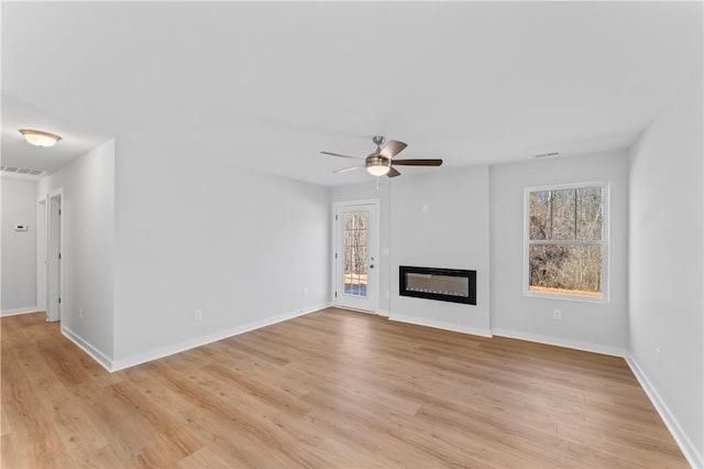 unfurnished living room with ceiling fan and light hardwood / wood-style floors