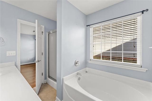 bathroom with separate shower and tub, tile patterned flooring, and vanity