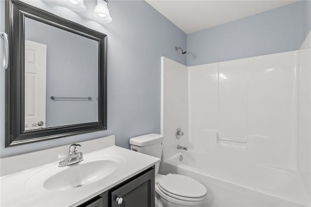 full bathroom featuring vanity, bathing tub / shower combination, and toilet