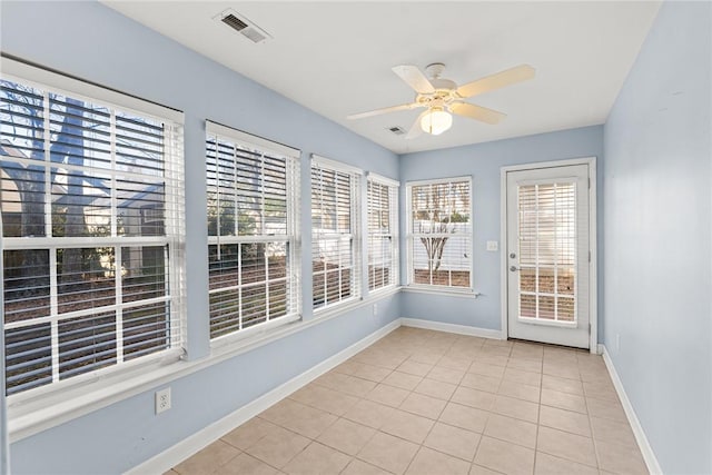 unfurnished sunroom featuring ceiling fan