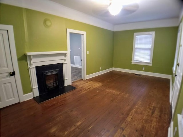 unfurnished living room featuring ceiling fan and dark hardwood / wood-style floors