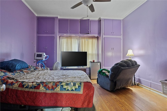 bedroom with light wood-type flooring and crown molding