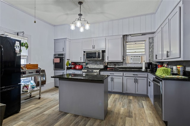 kitchen with gray cabinets, pendant lighting, black appliances, and a kitchen island