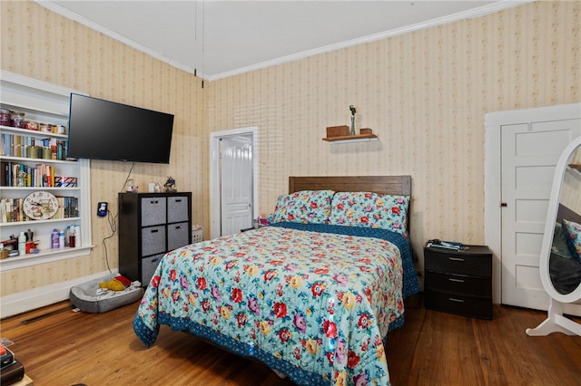 bedroom featuring hardwood / wood-style flooring and ornamental molding